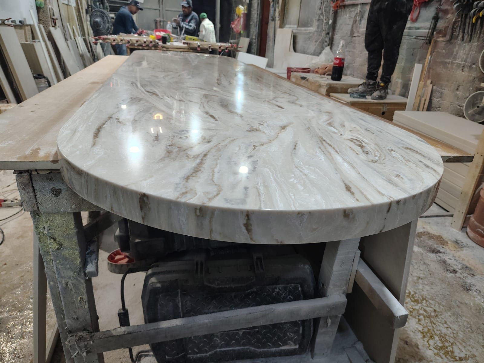 Cubierta ovalada de tono veteado sobre la mesa de trabajo del taller